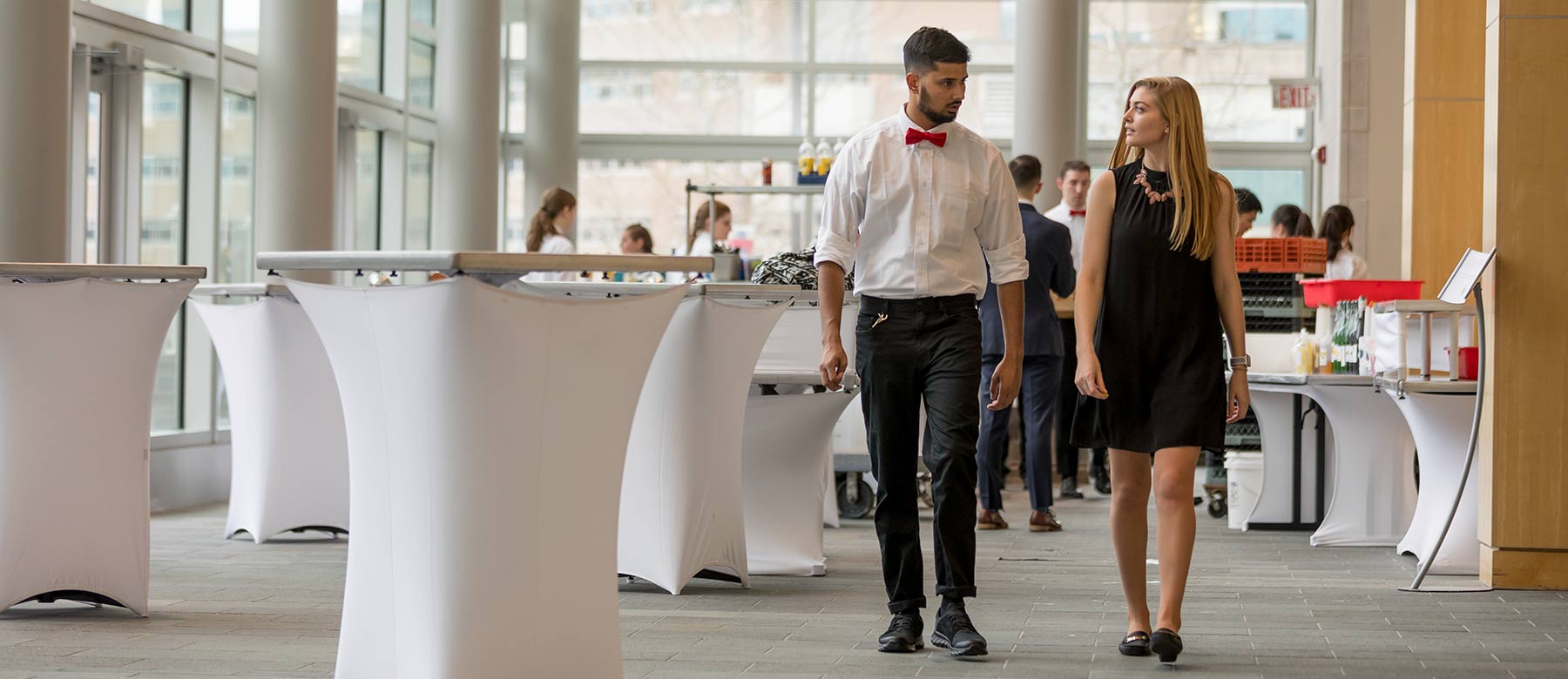 Two students walking in business attire