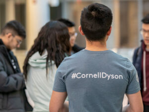 A student wearing a #CornellDyson shirt