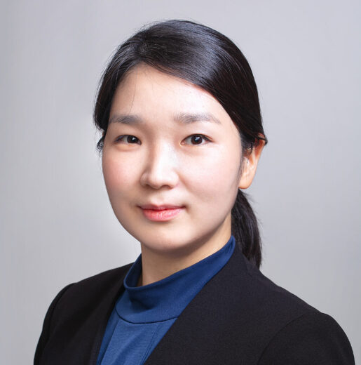 Lauren Chae smiling and wearing business attire.